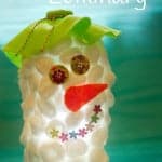 These fluffy Snowman Luminaries look cute during the day and just adorable glowing in the evenings! An easy and frugal recycled snowman craft for kids.