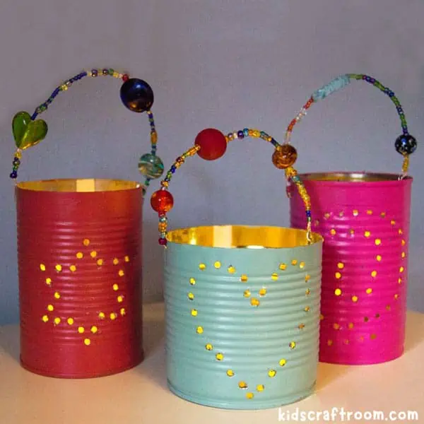 Three pretty tin can lanterns in a row.