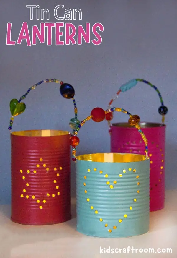Two tin can lanterns showing there designs made from drilled holes. The left has a star and the right has a heart.