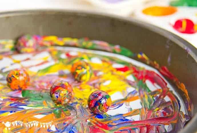 Have fun creating dynamic art with colorful marble painting. Kids will love experimenting with painting and color mixing in a new and physical way.