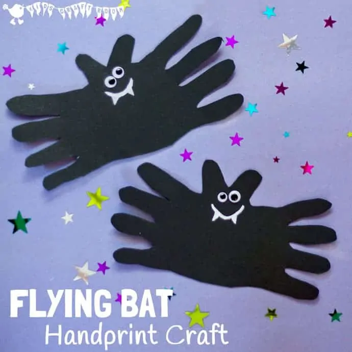 Two Halloween bat crafts. Each is made from black paper and handprints. The fingers make the wings and the thumbs make the ears. They have googly eyes and a white smile with fangs.