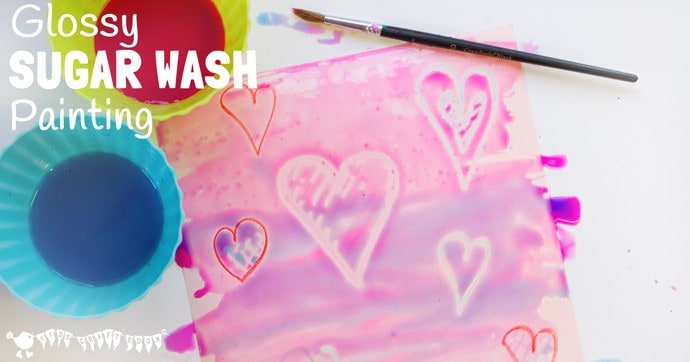 WAX RESIST SUGAR WASH PAINTING is a special and unusual painting activity for kids. It's colourful, glossy and finger licking good fun! Kids will love it! #valentine #valentinesday #valentinescraft #valentinecraft #valentinescrafts #valentinecrafts #valentinesdayforkids #heart #love #kidsart #processart #painting #paintingideas #kidspainting #paintingforkids #heartcrafts #kidscrafts #craftsforkids #kidsactivities #activitiesforkids #preschool #ECE