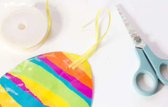 This EASTER EGG SUNCATCHER CRAFT for kids is so bright and colourful. They look beautiful hanging in windows and they can be hung outside for Easter egg hunts too.