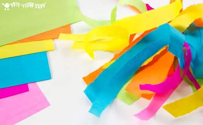 tearing-paper-strips-to-make-an-easter-egg-suncatcher-craft-with-tissue-paper