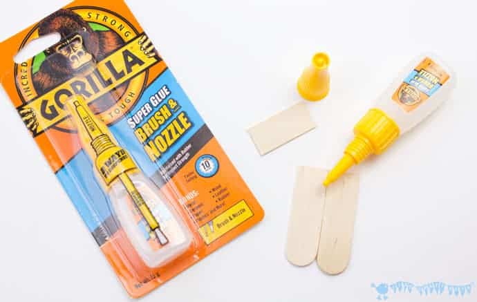 Glueing-popsicle-sticks-to-make-a-mix-n-match-snake-craft