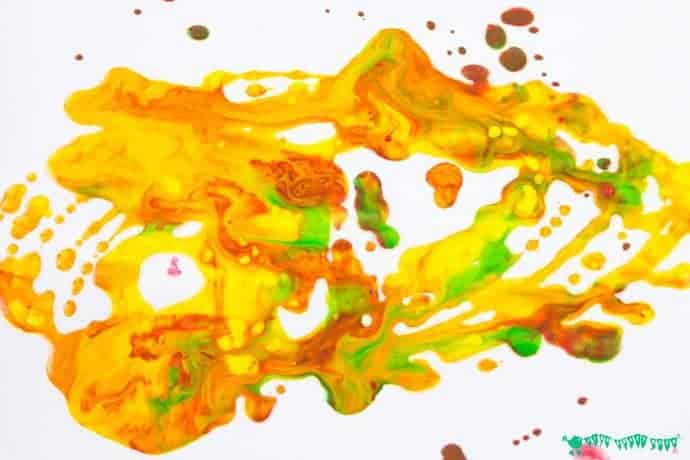 Swing, spin, splatter! We LOVE this LEGO® Pendulum Painting process art activity for kids and know that you will too! It's one of over 100 ways to create, play and learn with LEGO.