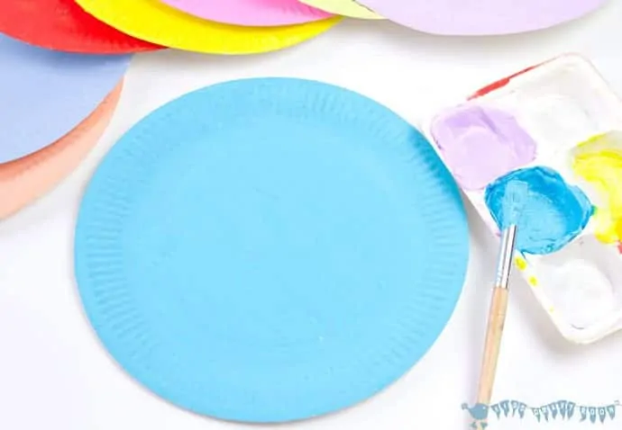 painting-paper-plates-to-make-paper-plate-rosettes-grandparents-day-craft