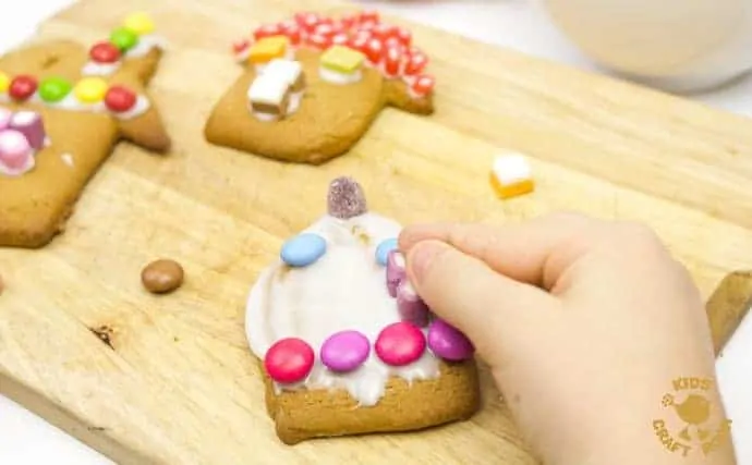 This easy gingerbread house recipe is great fun for the whole family. Forget the frustrations of 3D houses that fall down and make pretty 2D gingerbread houses instead. Just as pretty and delicious but without all the hassle! These cute gingerbread houses can be hung on the Christmas tree and given as gifts too - step-5