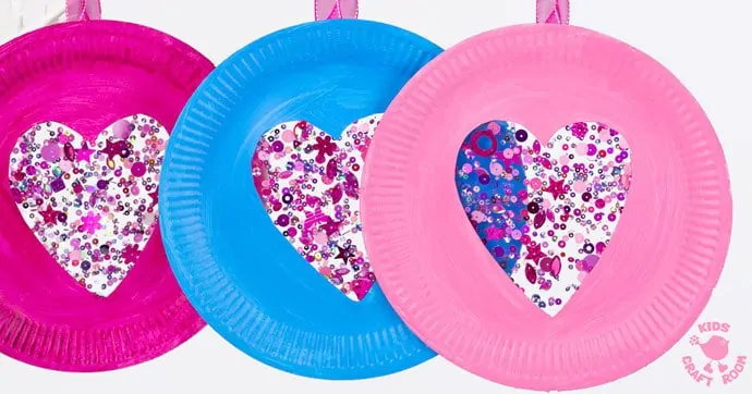 This PAPER PLATE HEART SUNCATCHER CRAFT is gorgeous! A simple heart craft perfect for Valentine's Day, Mother's Day and Summer. Great for all ages from toddlers to tweens. #valentine #valentinesday #valentinescraft #valentinecraft #valentinescrafts #valentinecrafts #valentinesdayforkids #heart #love #paperplate #paperplatecrafts #kidscrafts #heartcrafts #craftsforkids #kidscraftroom
