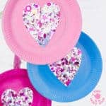 This PAPER PLATE HEART SUNCATCHER CRAFT is gorgeous! A simple heart craft perfect for Valentine's Day, Mother's Day and Summer. Great for all ages from toddlers to tweens. #valentine #valentinesday #valentinescraft #valentinecraft #valentinescrafts #valentinecrafts #valentinesdayforkids #heart #love #paperplate #paperplatecrafts #kidscrafts #heartcrafts #craftsforkids #kidscraftroom