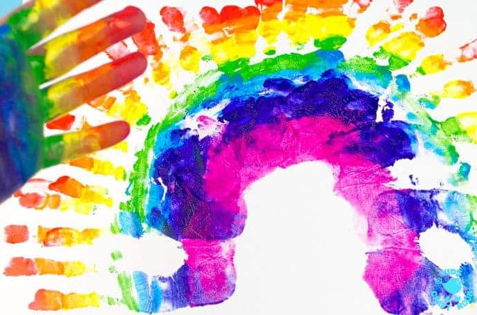 HANDPRINT RAINBOW PAINTING is a fun sensory art experience for kids. Get "hands-on" with paints and explore colour mixing and blending! A creative painting idea for St Patrick's Day and weather study themes.