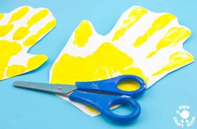 Handprint Chick Puppet Craft step 1 - Handprint Chick Puppets are a great Spring craft or Easter craft for kids. This chick craft looks super cute and kids can actually play with them too! Such a fun handprint craft to encourage dramatic play and story telling.