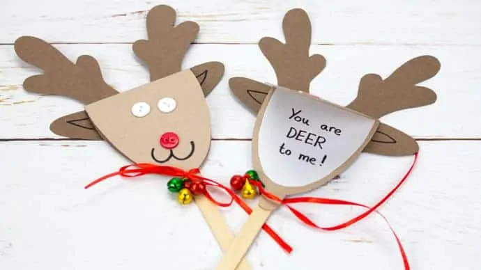 two reindeer puppet greeting cards lying next to each other. The one on the left is closed showing how to use it as a puppet and the one on the right is open to show it as a Christmas card, with a message inside.