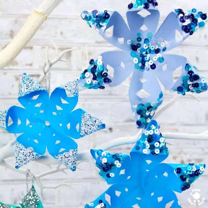 A close up of 3D paper snowflakes.