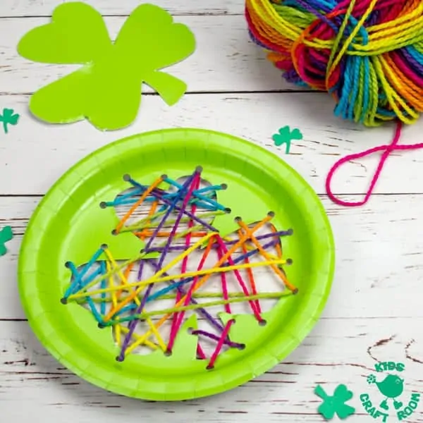 This paper plate St Patrick's Day Shamrock Lacing Craft is fun for kids to practise fine motor skills as they lace and sew a colourful rainbow shamrock leaf! An easy St Patrick's Day craft for kids. Paper plate crafts are so fun! #kidscraftroom #shamrock #stpatricksdaycrafts #stpatricksdaydecorations #paperplatecrafts #kidscrafts #preschoolcrafts 
