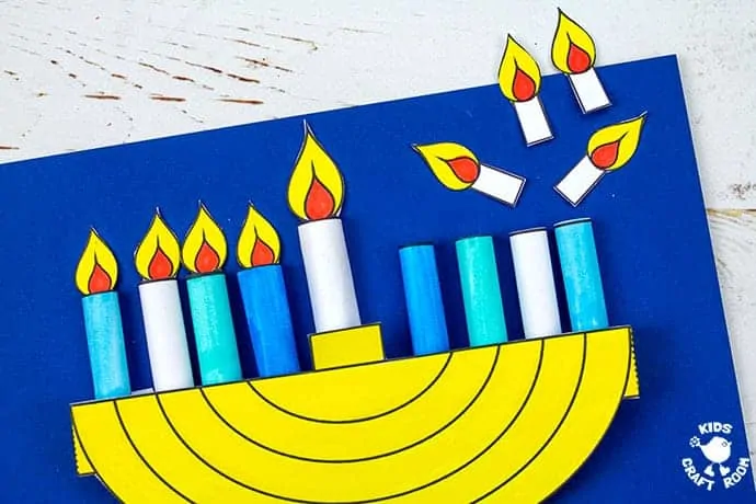 A paper menorah craft with half of the candle flames removed.