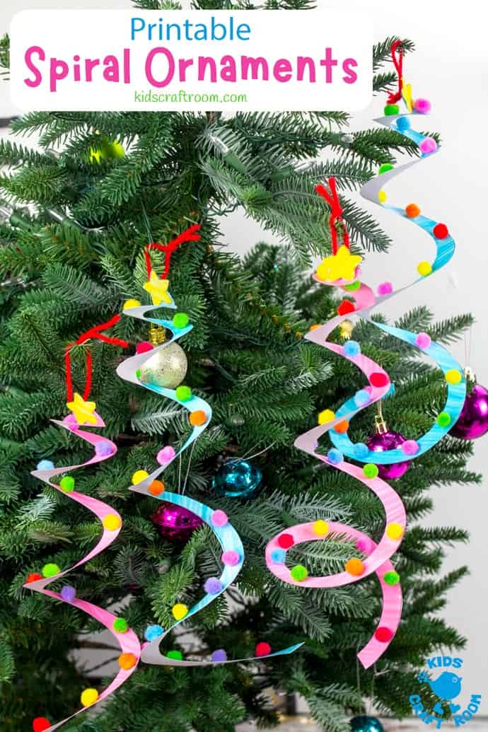 Four spiral tree ornaments hanging on a tree. They are made from paper and are decorated with colourful mini pompoms.
