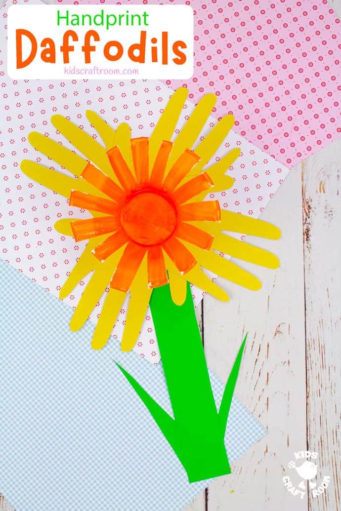 A finished handprint daffodil craft for kids lying in a selection of pretty coloured papers.