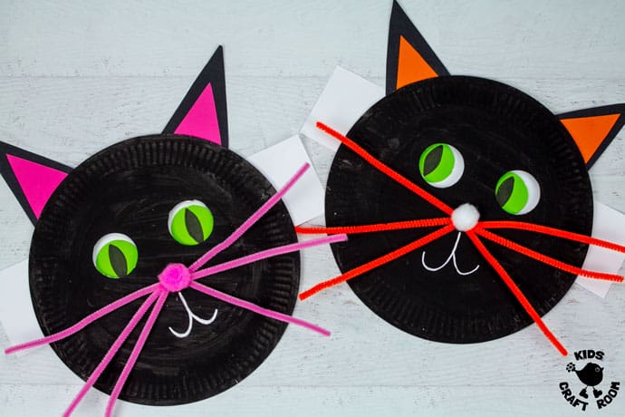 Paper Plate Moving Eyes Cat Crafts lying on a white table top.