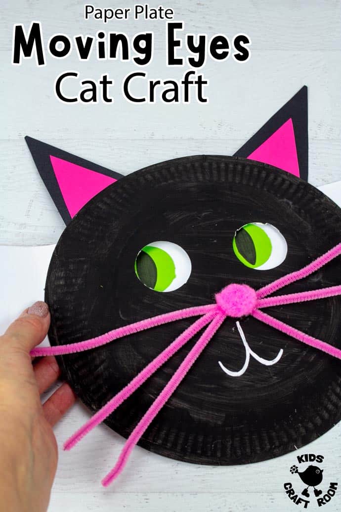 A close up of a Paper Plate Moving Eyes Cat Craft. it has a pink pom pom nose and pink whiskers.