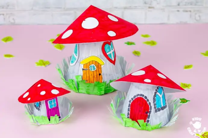 Mushroom Fairy House Craft finished and displayed on a pink table top in three sizes. 