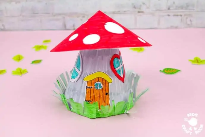 Mushroom Fairy House Craft on a pink table top.