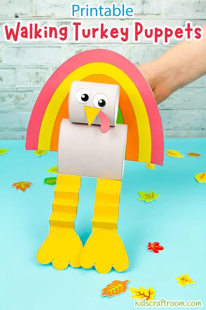 A hand holding a turkey puppet and walking it along a blue table top.