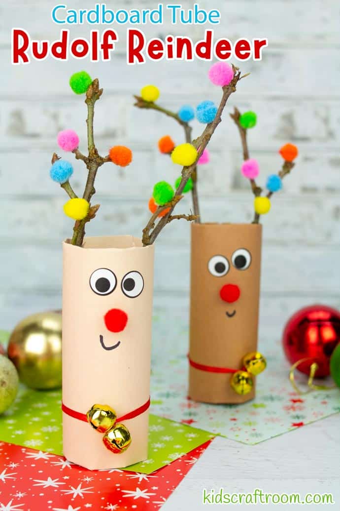 A close up of a light brown cardboard tube reindeer. It has antlers made from twigs that are decorated with colourful mini pompoms.