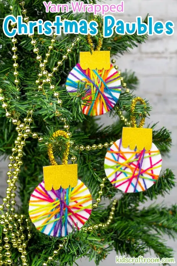 3 yarn wrapped baubles hanging on a Christmas Tree. 