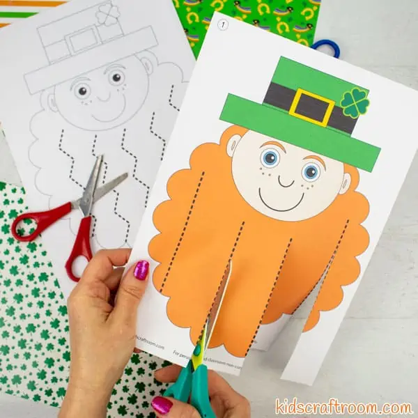 Square image showing Leprechaun Scissor Skills Activity for St Patrick's Day being cut with scissors.