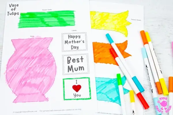 Mothers Day Tulip Craft templates coloured in with pens lying on a table.