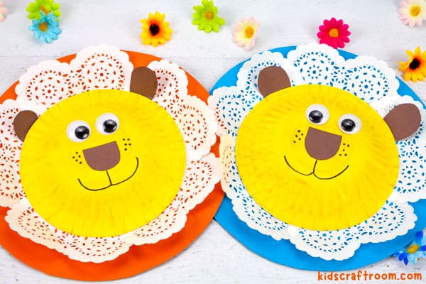 2 Lion crafts with doily manes lying side by side. 
