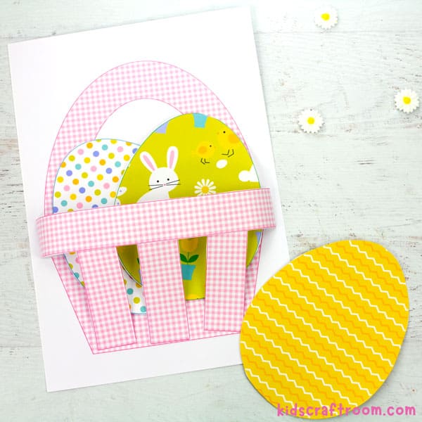 A pink gingham paper easter basket filled with paper eggs.