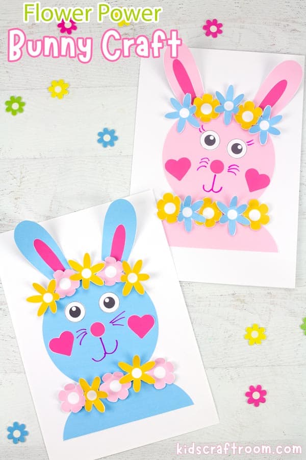 A pink and blue Flower power bunny craft lying one above the other on a white wood tabletop.