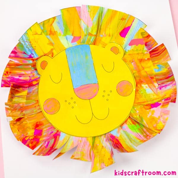 A colourful scrape painting lion craft with a blue nose on a white background.