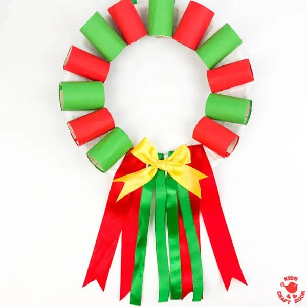 A red and green Paper Plate and Cardboard Tube Christmas Wreath Craft on a white background.