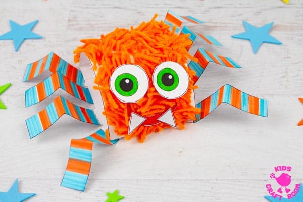 A close up of an orange and blue printable hairy spider craft.