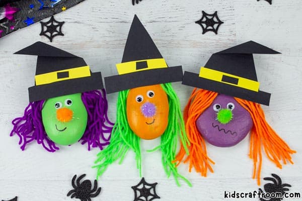 3 Rock Witch crafts for kids in a row. the first has purple hair, the second has green and the third has orange.