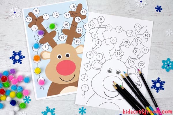 A coloured and black and white Christmas Lights Reindeer Advent Calendar on a tabletop. There are pencil crayons for colouring in and pom poms for covering the daily light.
