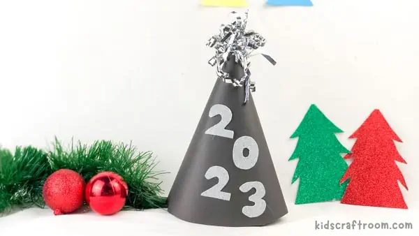 A black New Year Party Hat with silver numbers on the side and a silver sparkly topper.