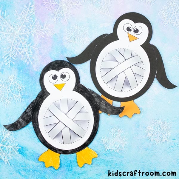 Two Pot Belly Penguin Crafts on a blue background surrounded by snowflakes.
