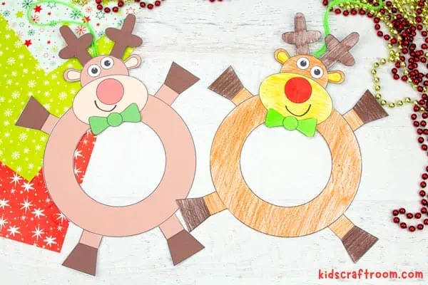 Two Reindeer Wreath Crafts lying side by side. The left is ready coloured, the right has been coloured in with pencils.