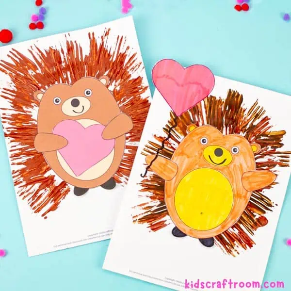Fork Painted Hedgehogs lying on a blue tabletop. Both are smiling and holding Valentine hearts.