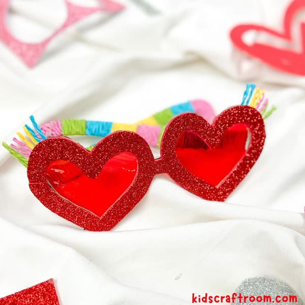 A close up of the red cellophane lenses of the Heart Sunglasses Craft.