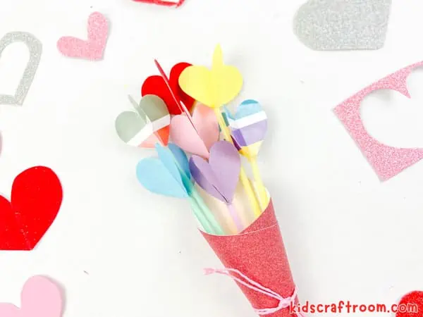 A finished Heart Bouquet Craft For Kids lying on a white tabletop.
