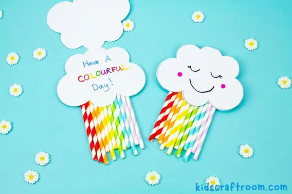A close up of a rainbow card craft, one open and one shut.