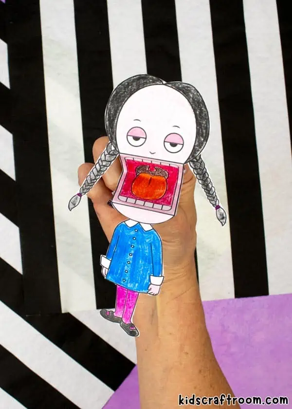 A close up of Addams Family Wednesday Paper Puppet.