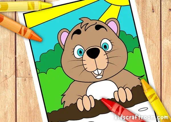 A groundhog coloring sheet that has been partially colored with wax crayons.