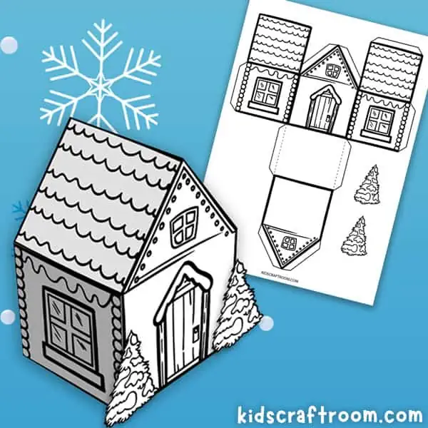 A paper house template on a blue background. In the foreground there is a built 3D winter paper house with a snowy fir tree on either side of the door.
