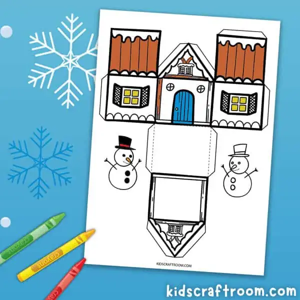 A paper winter house template partially colored with wax crayons.